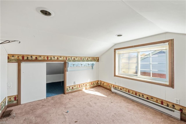 additional living space with a baseboard radiator, carpet floors, visible vents, and vaulted ceiling