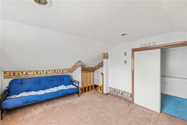 bedroom featuring a closet, carpet floors, and vaulted ceiling