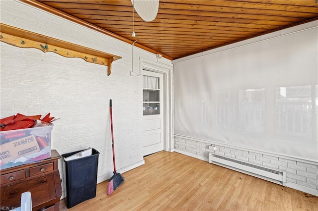 interior space with wood ceiling, brick wall, wood finished floors, and baseboard heating