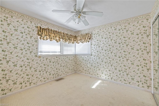 empty room featuring wallpapered walls, baseboards, and visible vents