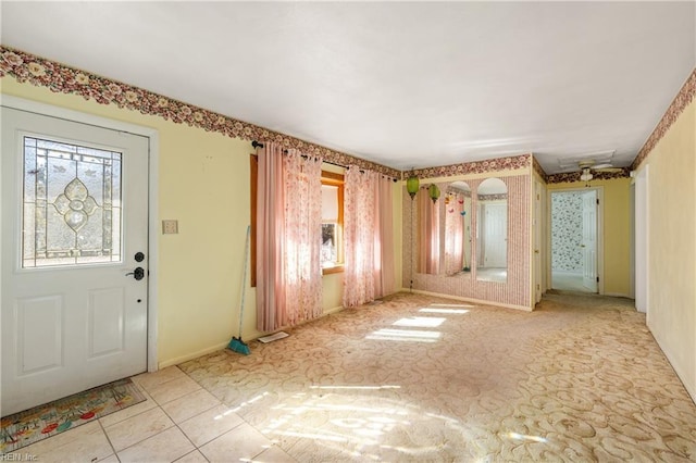 entrance foyer with tile patterned flooring and baseboards