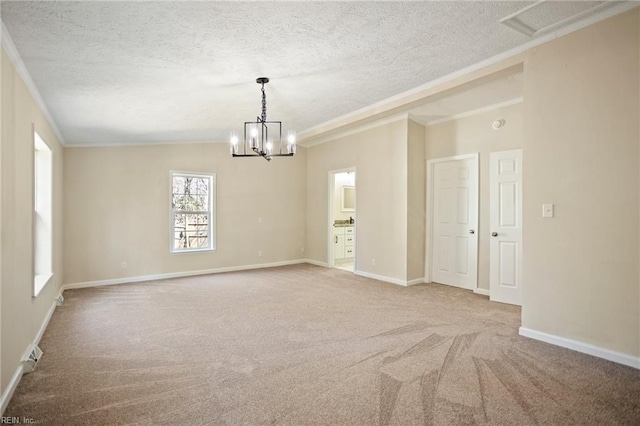 unfurnished room featuring baseboards, carpet, a chandelier, ornamental molding, and a textured ceiling