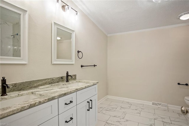 bathroom with marble finish floor, a textured ceiling, baseboards, and a sink