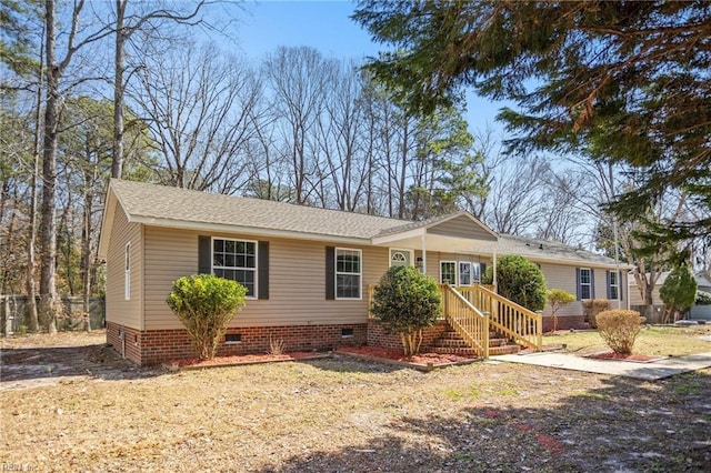 view of front of house featuring roof with shingles and crawl space