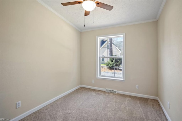 empty room featuring a ceiling fan, carpet, visible vents, ornamental molding, and a textured ceiling