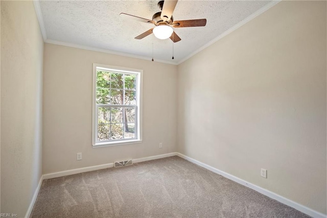 carpeted spare room featuring a textured ceiling, crown molding, visible vents, and ceiling fan