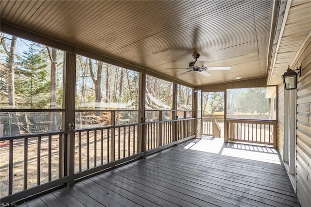 unfurnished sunroom featuring a ceiling fan