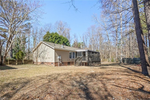 rear view of property featuring crawl space, fence, a yard, and a sunroom