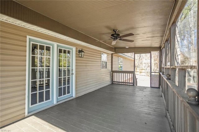 wooden deck with a ceiling fan