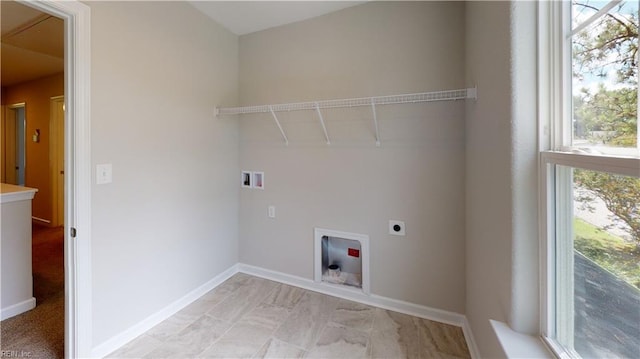 clothes washing area with electric dryer hookup, baseboards, washer hookup, and laundry area