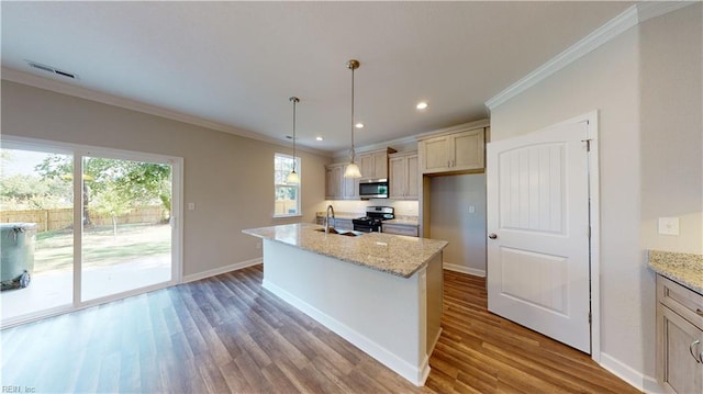 kitchen with visible vents, baseboards, ornamental molding, wood finished floors, and stainless steel appliances