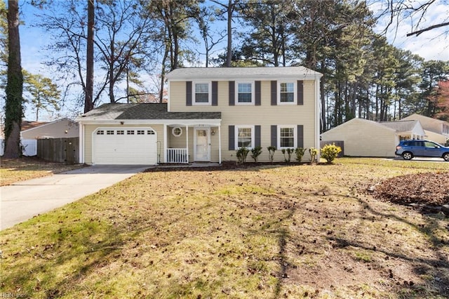 colonial inspired home with concrete driveway, a garage, and fence