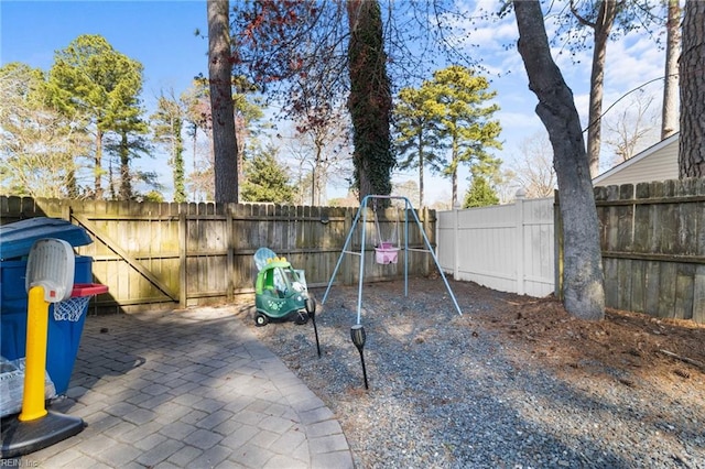 view of jungle gym featuring a patio and a fenced backyard