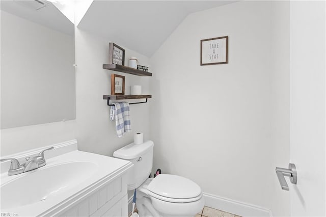 bathroom with visible vents, baseboards, toilet, vaulted ceiling, and vanity