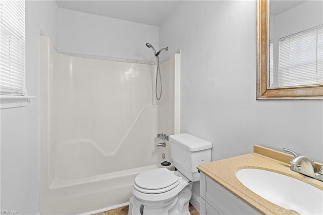 bathroom featuring vanity, toilet, and  shower combination