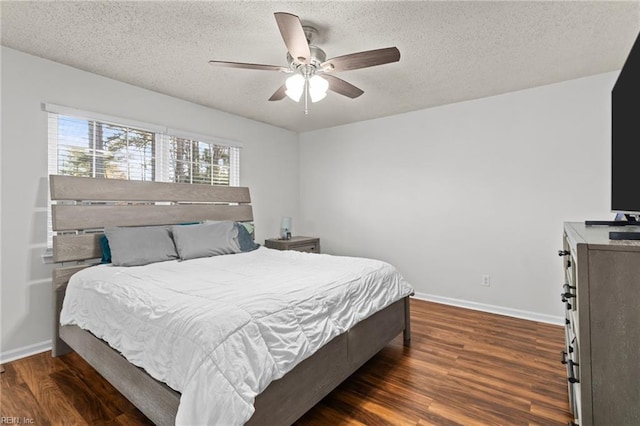 bedroom featuring baseboards, a textured ceiling, wood finished floors, and a ceiling fan