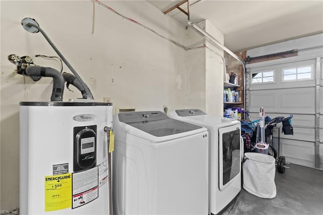 washroom with a garage, electric water heater, laundry area, and washer and clothes dryer