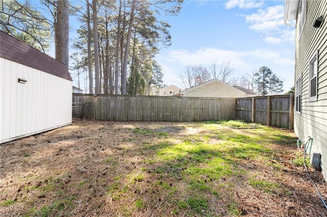 view of yard featuring an outbuilding and a fenced backyard