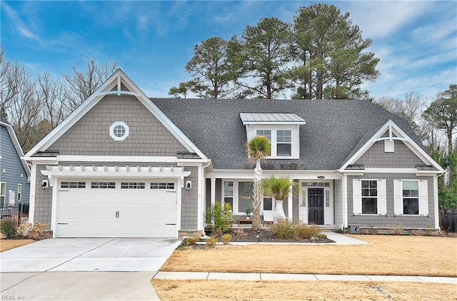 view of front of home featuring driveway, a front lawn, a garage, and roof with shingles