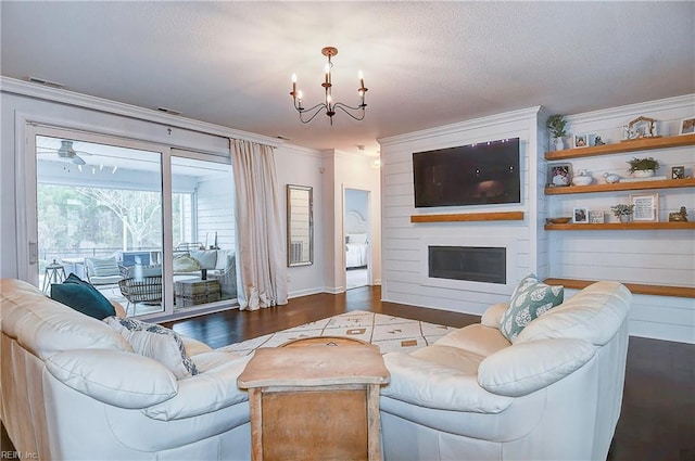 living room featuring visible vents, crown molding, a chandelier, a fireplace, and dark wood-style floors