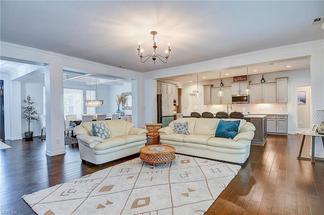 living area featuring baseboards, an inviting chandelier, ornamental molding, and dark wood-style flooring