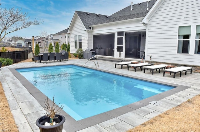 view of swimming pool with a fenced in pool, a patio area, fence, and a grill