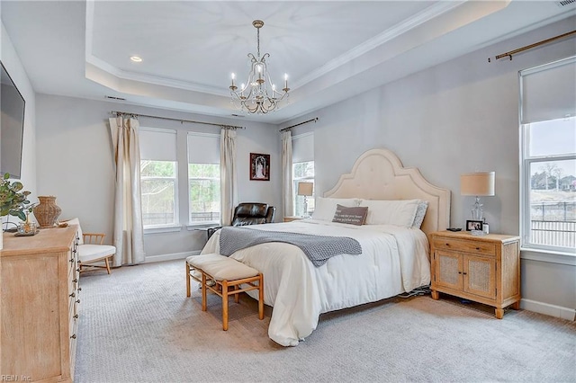 bedroom with crown molding, baseboards, light colored carpet, an inviting chandelier, and a raised ceiling