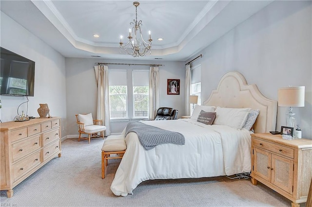 bedroom with baseboards, a tray ceiling, ornamental molding, light carpet, and a notable chandelier