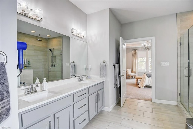 full bathroom with a sink, an inviting chandelier, ensuite bath, and a shower stall