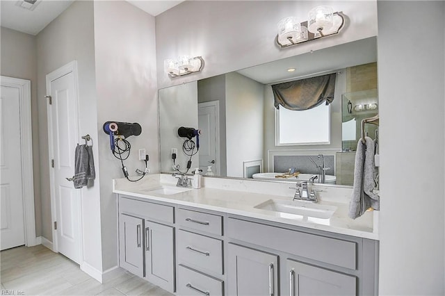 bathroom featuring a sink, toilet, and double vanity