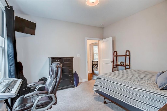 carpeted bedroom with baseboards