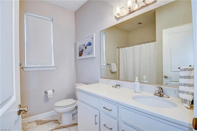 bathroom featuring vanity, toilet, baseboards, and marble finish floor