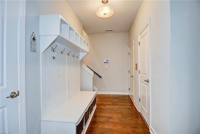 mudroom with visible vents, baseboards, and dark wood-style floors