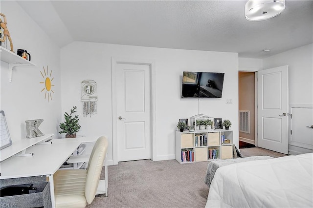 carpeted bedroom featuring lofted ceiling, baseboards, and visible vents