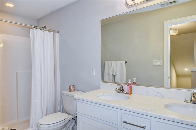 bathroom featuring a sink, visible vents, toilet, and a shower with shower curtain