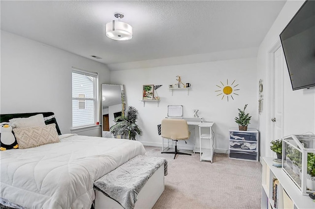 carpeted bedroom featuring visible vents and baseboards