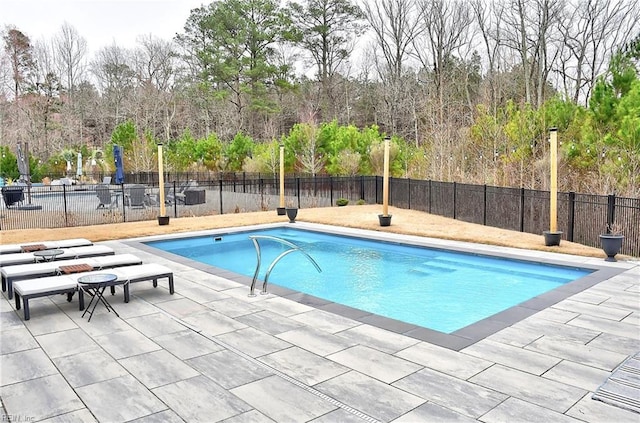 view of swimming pool featuring a fenced in pool, a patio, and fence