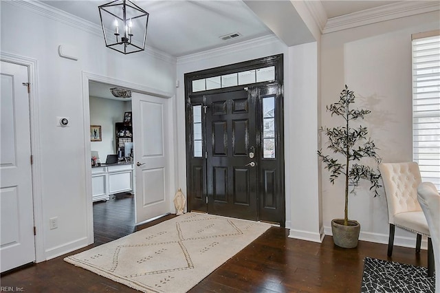 entryway featuring visible vents, a notable chandelier, dark wood finished floors, and crown molding