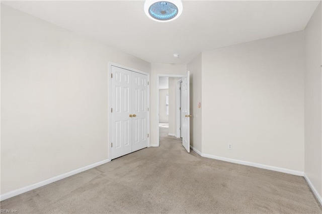 interior space with a closet, baseboards, and carpet floors