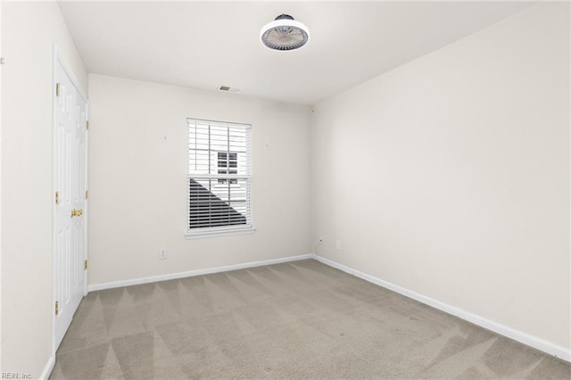 spare room featuring visible vents, baseboards, and carpet floors