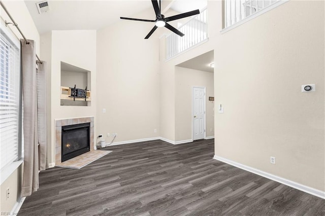 unfurnished living room with visible vents, baseboards, ceiling fan, a fireplace, and dark wood-style floors