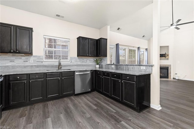 kitchen with a sink, visible vents, dishwasher, and dark cabinetry