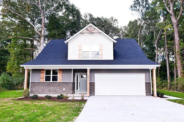 view of front of property with a front lawn, an attached garage, brick siding, and driveway