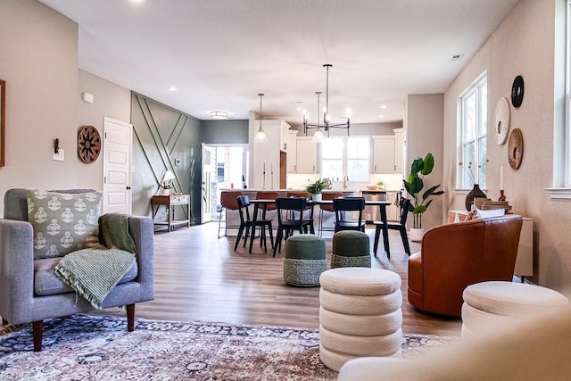 living room with a chandelier, recessed lighting, and wood finished floors