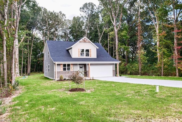 view of front of property with a garage, driveway, and a front yard