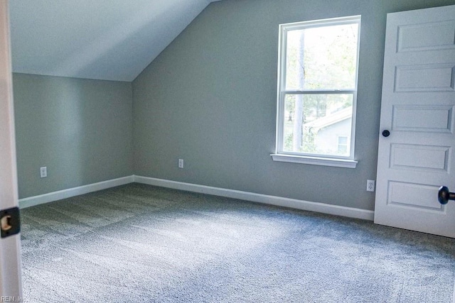 additional living space featuring carpet flooring, baseboards, and vaulted ceiling