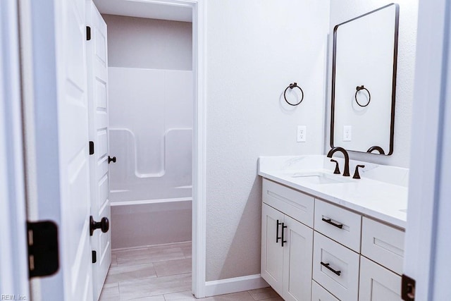 full bathroom featuring double vanity and a sink