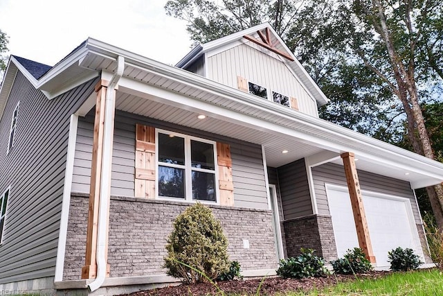 view of home's exterior with a garage, stone siding, and brick siding