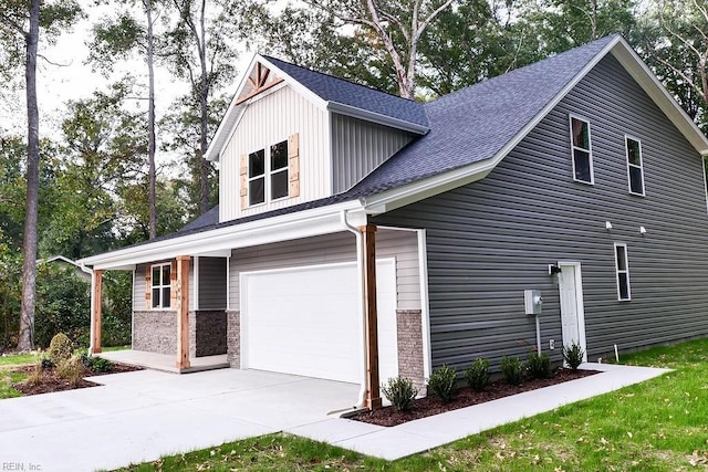 view of side of home featuring a garage, concrete driveway, and a shingled roof