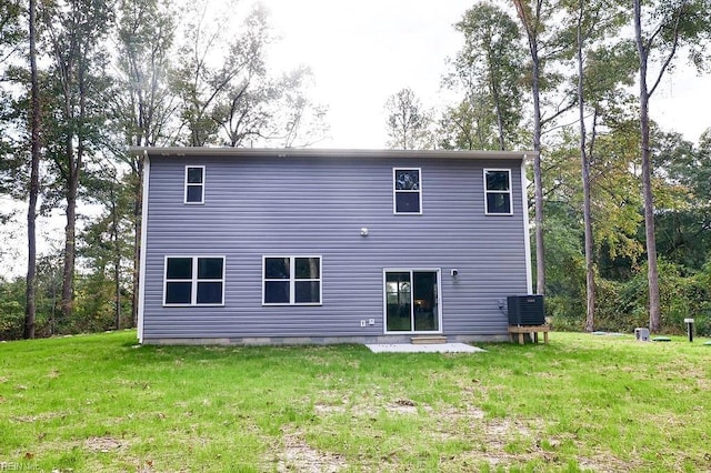 rear view of house with crawl space and a yard